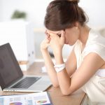 Young and beautiful businesswoman tired from work in the office